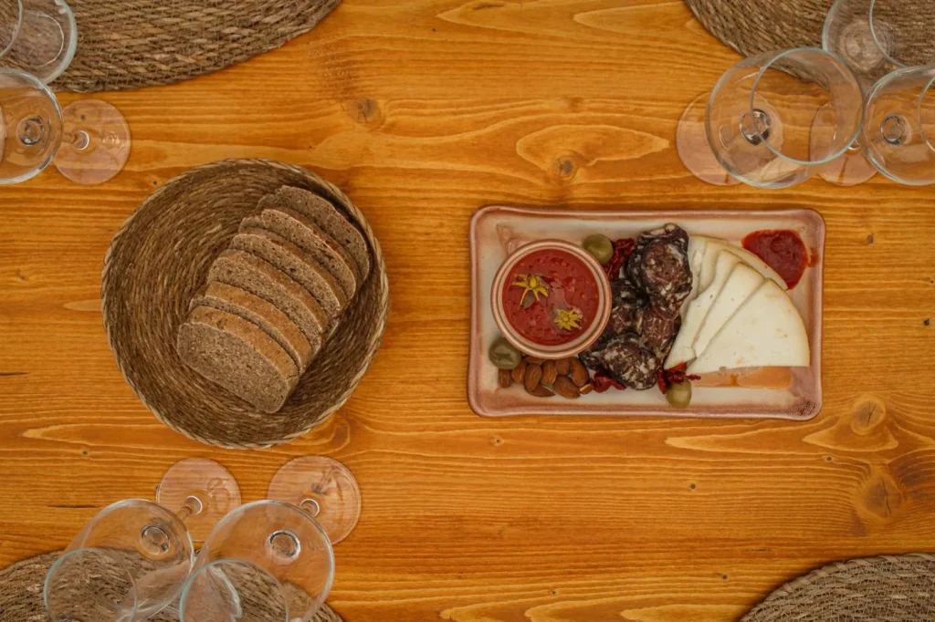 A platter of local Mallorcan products, including cured meats, cheese, bread, and tomatoes